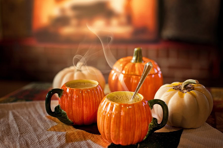 Funny Pumpkin Spice Memes Two Pumpkin-Shaped Mugs Filled with Hot Beverage with a Roaring Fireplace in the Background
