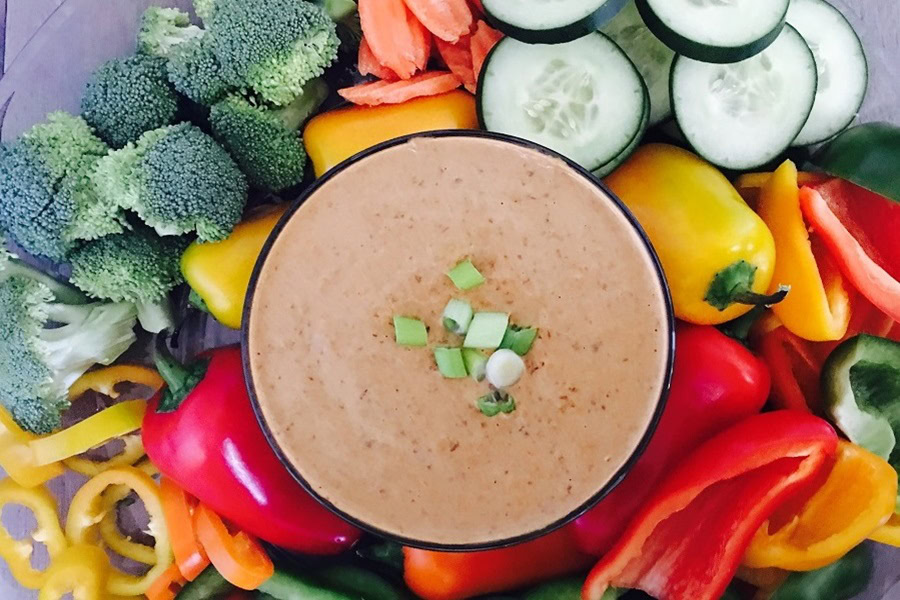 Memorial Day Pool Party Food Ideas Overhead of a Bowl of Bean Dip Surrounded with Veggies