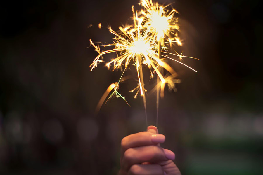 4th of July Cookies Close Up of a Sparkler in a Woman's Hand