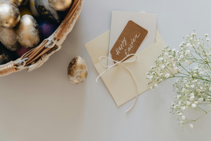 Christian Quotes for Easter Sunday a Wicker Bwol of Chocolate Eggs with One Egg Sitting Outside The Basket Next to a Tag that Says Happy Easter