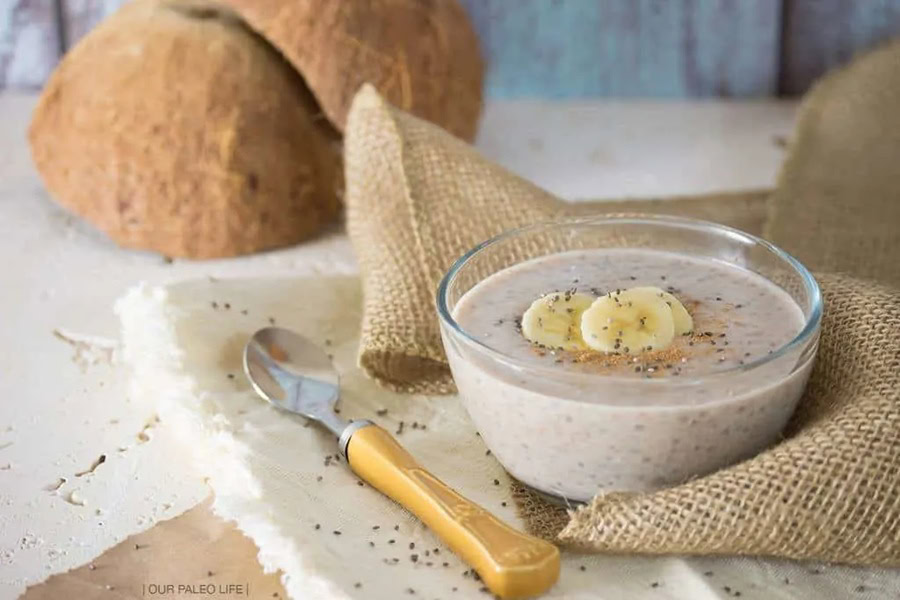 Whole30 Breakfast Recipes a Bowl of Paleo Banana Chia Pudding Recipe Topped with Banana Slices Next to a Napkin with a Spoon 