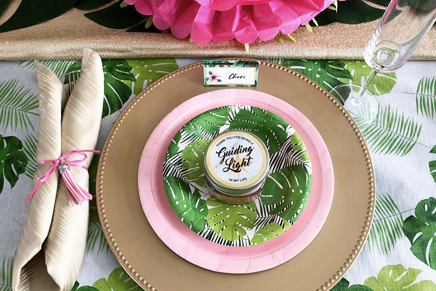 Mother&rsquo;s Day Brunch Decor Ideas Close Up of a Table Setting with a Tropical Leafe Design on the Plate and Table Cloth
