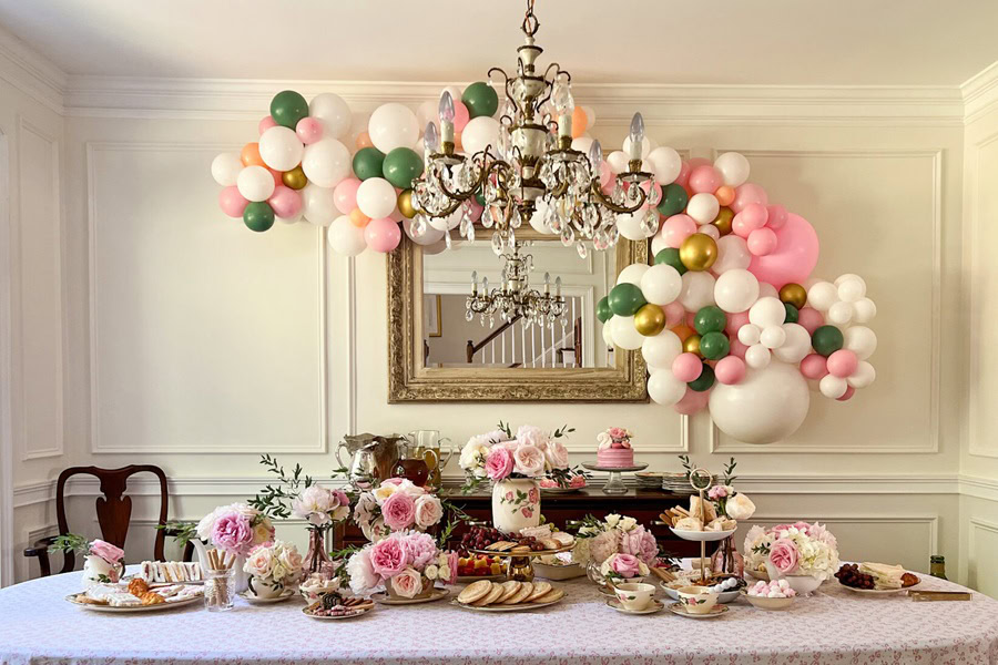 Mother&rsquo;s Day Brunch Decor Ideas a Dining Room with a Balloon Installation on a Wall Around a Mirror Behind a Dining Table with Food and Flowers 