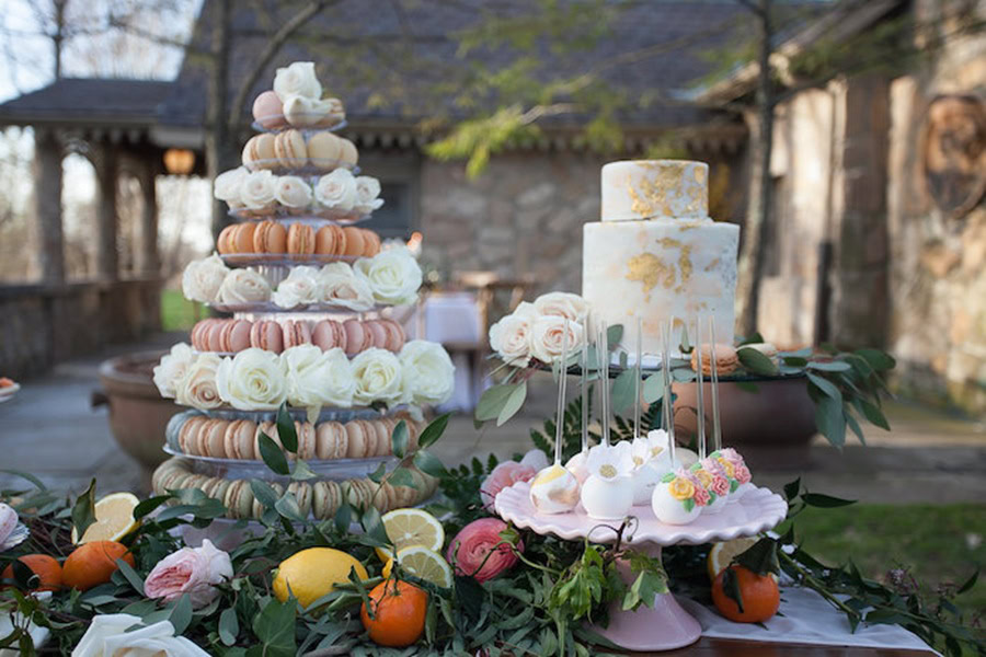 Mother&rsquo;s Day Brunch Decor Ideas a French Macaroon Tower Next to a Tiered Cake and a Platter of Cake Pops on a Table Outdoor