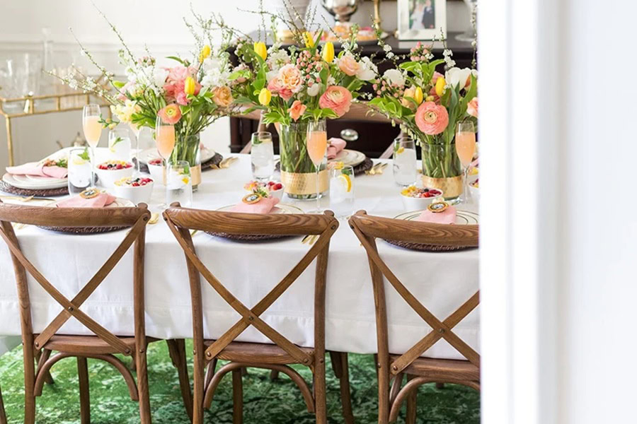 Mother&rsquo;s Day Brunch Decor Ideas a Dining Table with Flower Centerpieces with Wooden Chairs at the Table