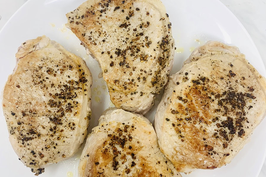 Whole30 Instant Pot Pork Chops Recipe Pork Chops Resting on a White Plate