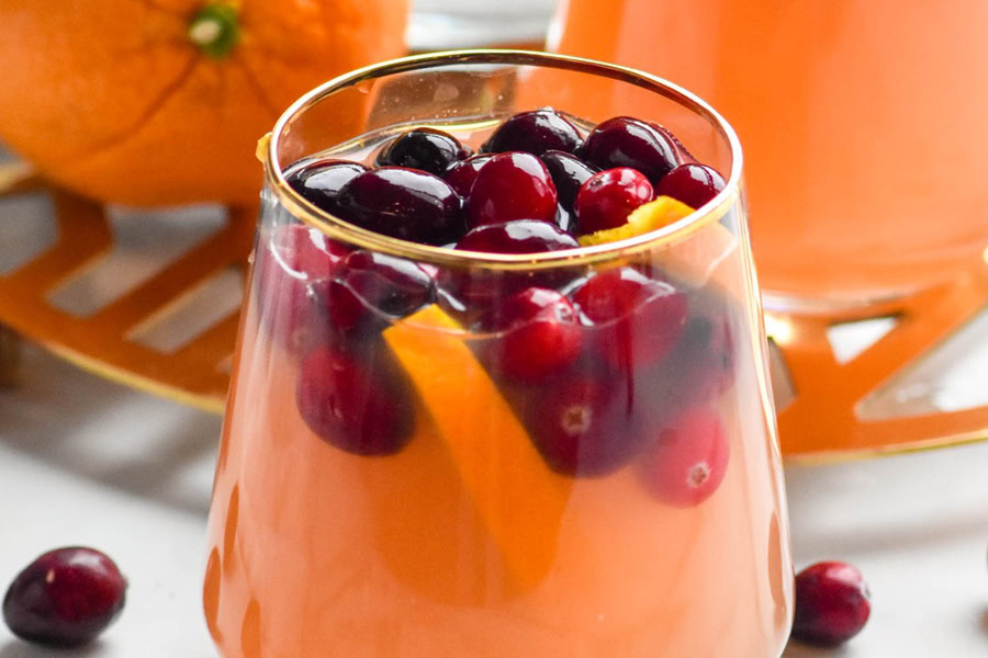 Sangria Recipes Cranberry Orange Margarita Sangria in a Wine Glass with a Golden Rim