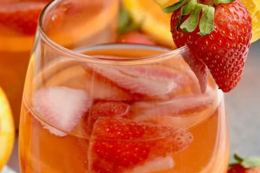 Sangria Recipes Sunset Sangria in a Glass with a Strawberry Garnish