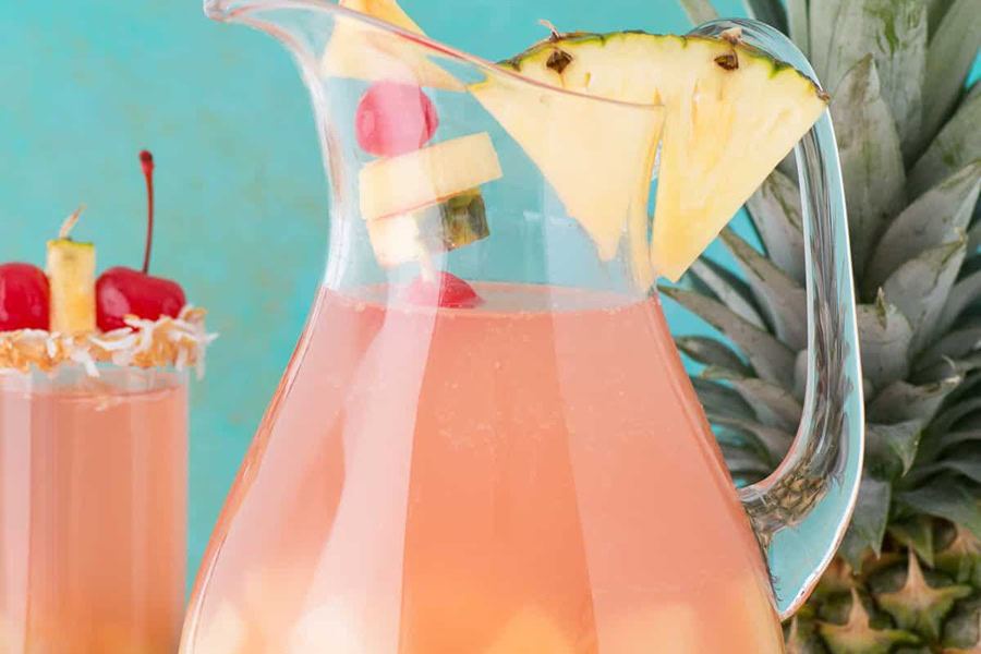 Sangria Recipes Piña Colada Sangría in a Pitcher Next to a Glass