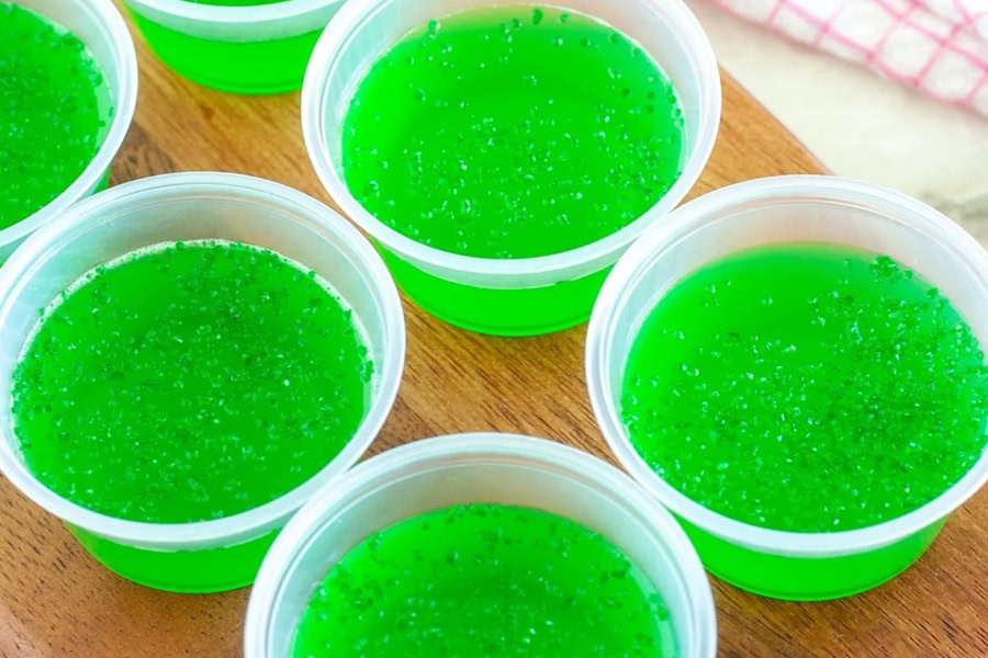 Tequila Jello Shot Recipes Tequila JELLO Shots in Small Plastic Cups on a Wooden Surface