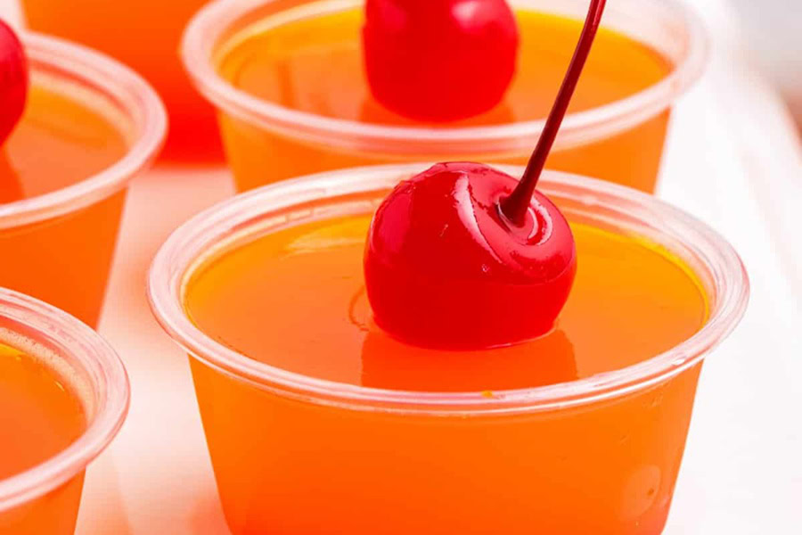 Tequila Jello Shot Recipes Tequila Sunrise Jello Shots Close Up Garnished with a Cherry