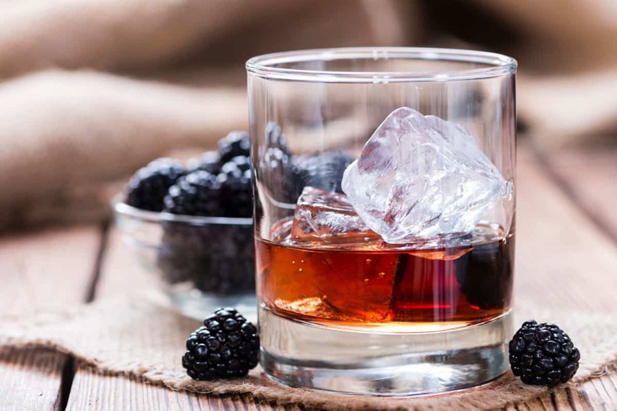 Whiskey Drinks for Summer Whiskey Blackberry Smash in a Glass with Ice