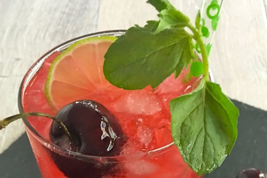 Backyard BBQ Drinks for an Outdoor Party Homemade Blackberry Mojito Recipe Garnished with a Cherry