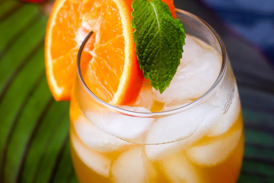 Backyard BBQ Drinks for an Outdoor Party Easy Fireball Cocktail Recipe in a Glass Garnished with an Orange Slice