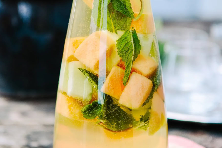 Backyard BBQ Drinks for an Outdoor Party Mixed Melon & Limoncello Sangria in a Pitcher
