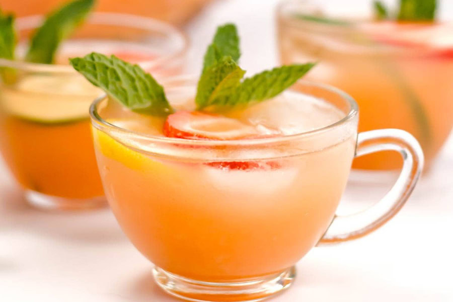 Backyard BBQ Drinks for an Outdoor Party Jungle Juice in Three Glasses Garnished with a Mint Sprig