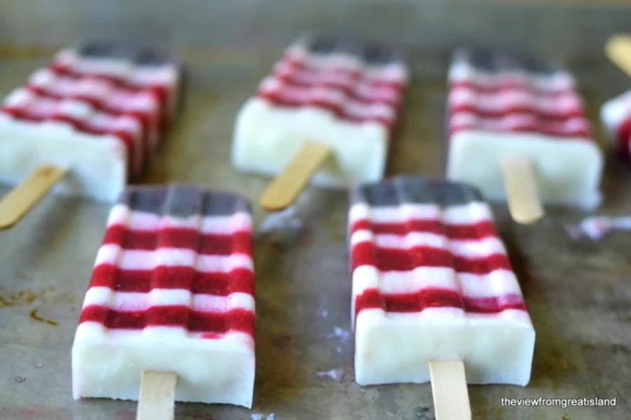 Red White and Blue Desserts Red White and Blueberry Yogurt Popsicles on a Serving Tray