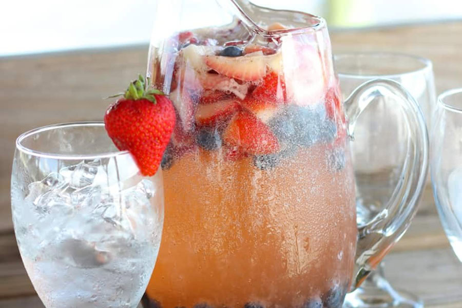 Red White and Blue Drink Recipes with Alcohol Red White and Blue Sangria in a Pitcher Next to a Glass with Ice