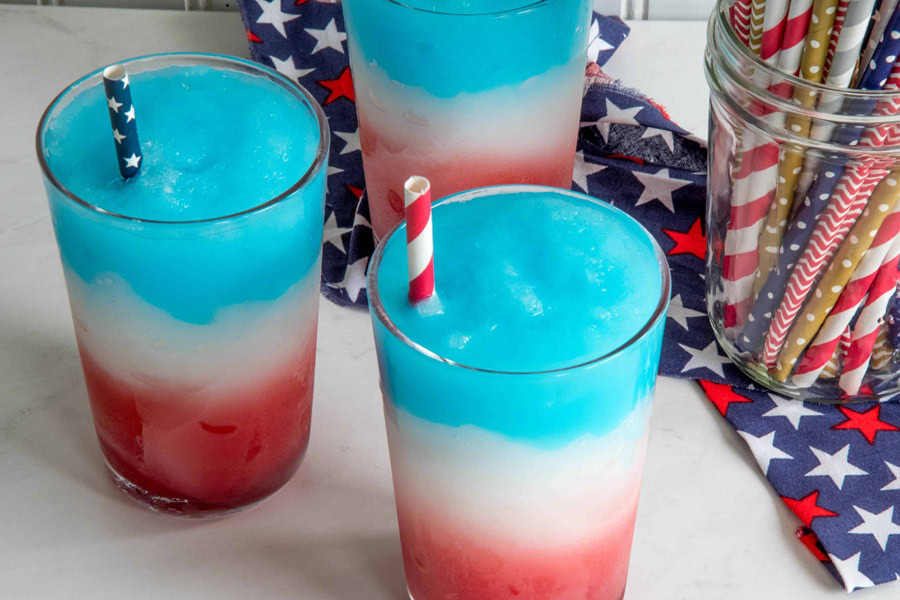 Red White and Blue Drinks 4th of July Slush Recipe in Three Glasses with American Flag Straws
