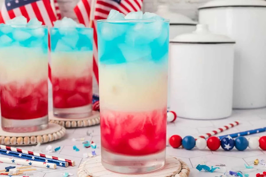 Red White and Blue Drinks Red White and Blue Drink in GLasses with Straws and Confetti Scattered Around