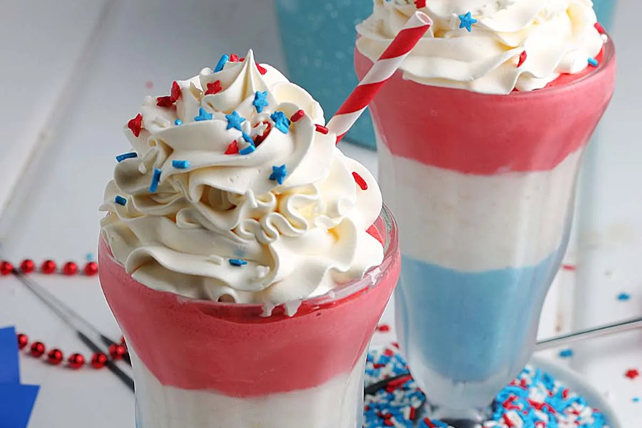 Red White and Blue Drinks 4th of July Milkshakes in Glasses Topped with Whipped Cream