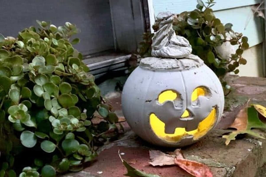 Halloween Decorations for a Spooky Party a DIY Cement Jack O’ Lantern Sitting on a Porch
