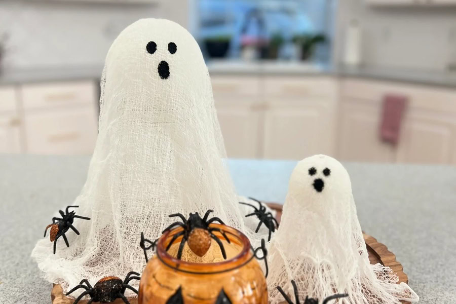 Halloween Decorations for a Spooky Party DIY Ghost Lanterns Sitting on a Counter