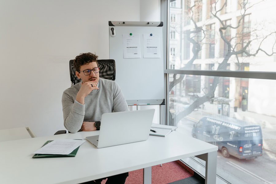Powerful Quotes For Entrepreneurs a Man Sitting at a Laptop in an Office
