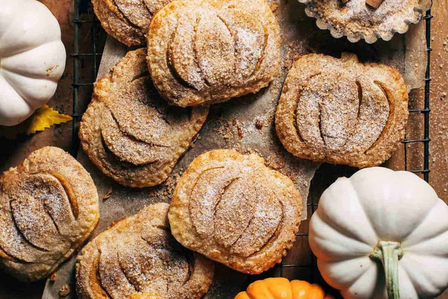 Halloween Party Food Ideas for Kids Close Up of Mini Pumpkin Hand Pies Dusted with Cinnamon Sugar