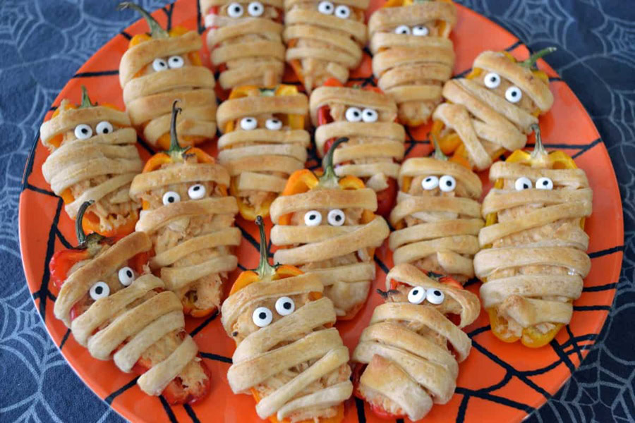 Halloween Party Food Ideas for Kids Taco-Stuffed Mini Sweet Pepper Mummies on an Orange Serving Platter
